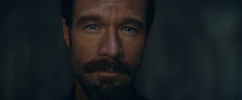 Movie still from “Red Notice” (2021), directed by Rawson Marshall Thurber – A person with a beard; Extreme Close Up shot, Low angle