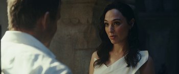 Movie still from “Red Notice” (2021), directed by Rawson Marshall Thurber – A woman in a white dress looking at a man in a white shirt; Close Up shot, Over the shoulder angle
