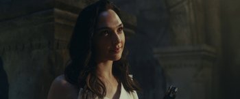 Movie still from “Red Notice” (2021), directed by Rawson Marshall Thurber – A beautiful young woman with long dark hair; Close Up shot, Over the shoulder angle