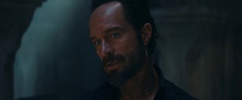 Movie still from “Red Notice” (2021), directed by Rawson Marshall Thurber – A person with a beard; Close Up shot, Over the shoulder angle