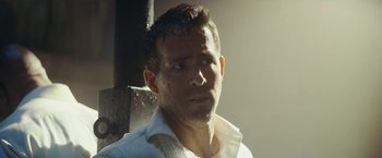 Movie still from “Red Notice” (2021), directed by Rawson Marshall Thurber – A person wearing a white shirt; Close Up shot, Over the shoulder angle