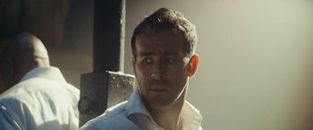 Movie still from “Red Notice” (2021), directed by Rawson Marshall Thurber – A person wearing a white shirt; Close Up shot, Low angle