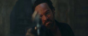 Movie still from “Red Notice” (2021), directed by Rawson Marshall Thurber – A person holding a gun; Close Up shot, Over the shoulder angle