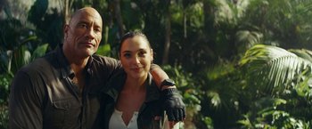 Movie still from “Red Notice” (2021), directed by Rawson Marshall Thurber – A man and a woman posing for a picture; Close Up shot, Low angle