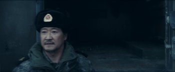 Movie still from “Red Notice” (2021), directed by Rawson Marshall Thurber – A man wearing a uniform and a hat; Close Up shot, Over the shoulder angle