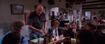Movie still from “Reservoir Dogs” (1992), directed by Quentin Tarantino – A group of men sitting at a table in a restaurant; Medium shot, Over the shoulder angle