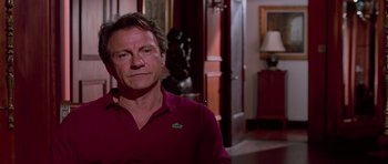 Movie still from “Reservoir Dogs” (1992), directed by Quentin Tarantino – A person sitting in a room; Close Up shot, Over the shoulder angle