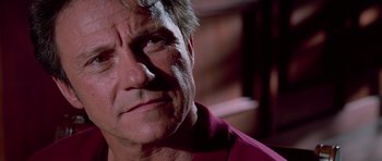 Movie still from “Reservoir Dogs” (1992), directed by Quentin Tarantino – A person wearing a red shirt; Close Up shot, Low angle