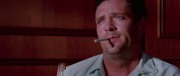 Movie still from “Reservoir Dogs” (1992), directed by Quentin Tarantino – A person smoking a cigarette; Close Up shot, Low angle