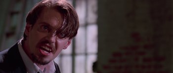 Movie still from “Reservoir Dogs” (1992), directed by Quentin Tarantino – A young boy with a shaved head and a white shirt; Close Up shot, Low angle