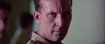 Movie still from “Reservoir Dogs” (1992), directed by Quentin Tarantino – A man's face in a military uniform; Close Up shot, Low angle