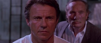 Movie still from “Reservoir Dogs” (1992), directed by Quentin Tarantino – A man's face in front of another man; Close Up shot, Low angle