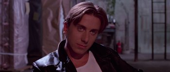 Movie still from “Reservoir Dogs” (1992), directed by Quentin Tarantino – A person wearing a leather jacket; Close Up shot, Low angle