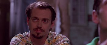 Movie still from “Reservoir Dogs” (1992), directed by Quentin Tarantino – A person wearing a shirt; Close Up shot, Over the shoulder angle