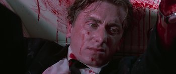 Movie still from “Reservoir Dogs” (1992), directed by Quentin Tarantino – A person with blood on his face; Close Up shot, Low angle