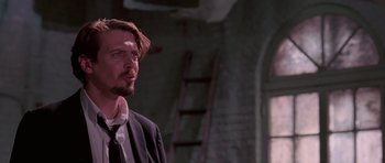 Movie still from “Reservoir Dogs” (1992), directed by Quentin Tarantino – A person wearing a suit and tie; Close Up shot, Low angle