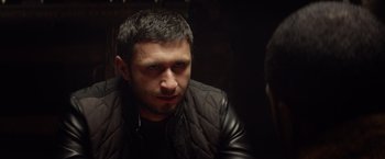 Movie still from “Ride Along” (2014), directed by Tim Story – A person wearing a leather jacket; Close Up shot, Over the shoulder angle