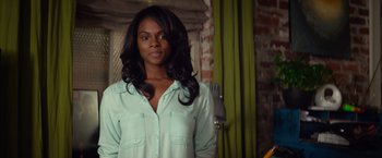 Movie still from “Ride Along” (2014), directed by Tim Story – A woman with long black hair standing in front of a brick wall; Close Up shot, Over the shoulder angle