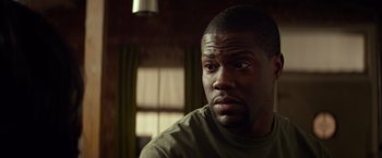 Movie still from “Ride Along” (2014), directed by Tim Story – A person sitting in front of a window; Close Up shot, Over the shoulder angle