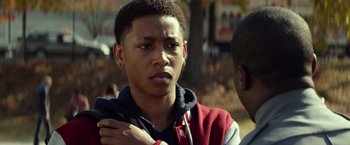 Movie still from “Ride Along” (2014), directed by Tim Story – A young man standing next to another young man; Close Up shot, Over the shoulder angle