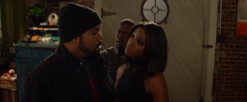 Movie still from “Ride Along” (2014), directed by Tim Story – Two men and a woman standing in front of each other; Medium shot, Over the shoulder angle