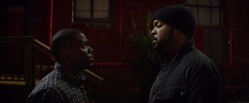 Movie still from “Ride Along” (2014), directed by Tim Story – Two men standing next to each other in a dark room; Close Up shot, Over the shoulder angle