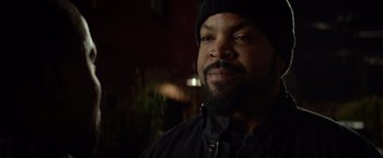 Movie still from “Ride Along” (2014), directed by Tim Story – A man with a beard wearing a black jacket and a hat; Close Up shot, Over the shoulder angle