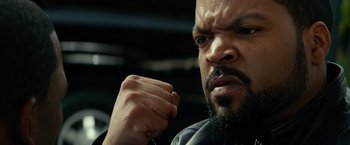 Movie still from “Ride Along” (2014), directed by Tim Story – A person with his fist up; Close Up shot, Over the shoulder angle