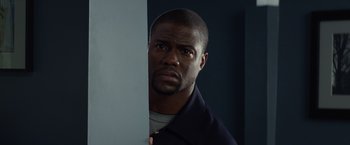 Movie still from “Ride Along” (2014), directed by Tim Story – A person standing next to a wall; Close Up shot, Over the shoulder angle
