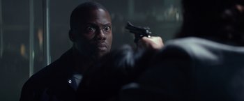 Movie still from “Ride Along” (2014), directed by Tim Story – A man holding a gun up to his face; Close Up shot, Over the shoulder angle