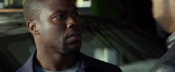 Movie still from “Ride Along” (2014), directed by Tim Story – A person with a beard looking to his left; Close Up shot, Over the shoulder angle