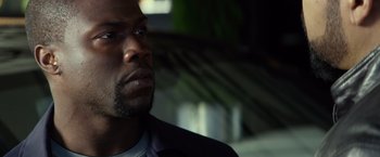 Movie still from “Ride Along” (2014), directed by Tim Story – A person wearing a suit and tie; Close Up shot, Over the shoulder angle
