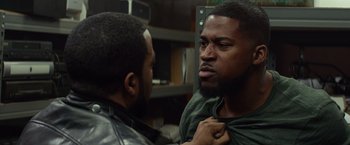 Movie still from “Ride Along” (2014), directed by Tim Story – Two men one of whom is wearing a leather jacket and the other is wearing a green shirt; Close Up shot, Over the shoulder angle
