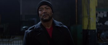 Movie still from “Ride Along” (2014), directed by Tim Story – A man wearing a black coat and a black hat; Close Up shot, Over the shoulder angle