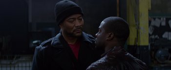 Movie still from “Ride Along” (2014), directed by Tim Story – Two men are talking to each other in a dark room; Close Up shot, Over the shoulder angle
