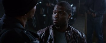 Movie still from “Ride Along” (2014), directed by Tim Story – A man in a leather jacket talking to another man; Close Up shot, Over the shoulder angle
