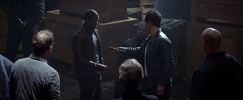 Movie still from “Ride Along” (2014), directed by Tim Story – A group of men standing next to each other in a room; Medium shot, Over the shoulder angle