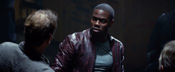 Movie still from “Ride Along” (2014), directed by Tim Story – A person wearing a leather jacket; Medium shot, Over the shoulder angle