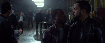 Movie still from “Ride Along” (2014), directed by Tim Story – A group of people walking in a warehouse; Medium shot, Over the shoulder angle