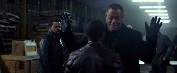 Movie still from “Ride Along” (2014), directed by Tim Story – A man in a black leather jacket and a man in a black leather jacket and a man in a black leather jacket; Medium shot, Over the shoulder angle