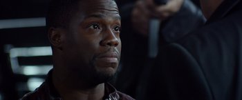 Movie still from “Ride Along” (2014), directed by Tim Story – A person looking up at something; Close Up shot, Over the shoulder angle