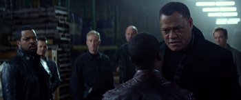 Movie still from “Ride Along” (2014), directed by Tim Story – A group of men standing next to each other in a room; Medium shot, Over the shoulder angle