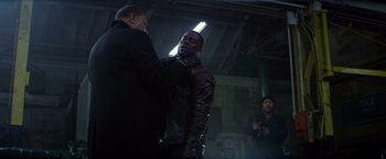 Movie still from “Ride Along” (2014), directed by Tim Story – A man in a leather jacket fixing another man's leather jacket; Medium shot, Over the shoulder angle