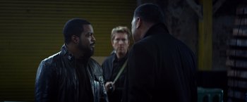 Movie still from “Ride Along” (2014), directed by Tim Story – A group of men standing next to each other; Medium shot, Over the shoulder angle