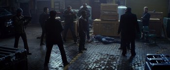 Movie still from “Ride Along” (2014), directed by Tim Story – A group of men standing around a dead body on the ground; Wide shot, High angle