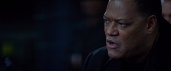 Movie still from “Ride Along” (2014), directed by Tim Story – An older black man in a black shirt looking to his left; Close Up shot, Over the shoulder angle