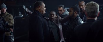 Movie still from “Ride Along” (2014), directed by Tim Story – A group of men standing next to each other in a room; Medium shot, Over the shoulder angle