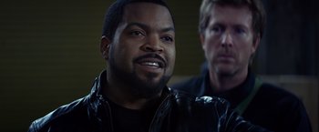 Movie still from “Ride Along” (2014), directed by Tim Story – A man in a leather jacket is looking at the camera; Close Up shot, Over the shoulder angle