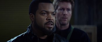 Movie still from “Ride Along” (2014), directed by Tim Story – Two men in leather jackets one of whom has a beard and one of whom has blond hair; Close Up shot, Over the shoulder angle