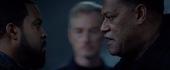 Movie still from “Ride Along” (2014), directed by Tim Story – Two men are looking at each other in the dark; Close Up shot, Over the shoulder angle